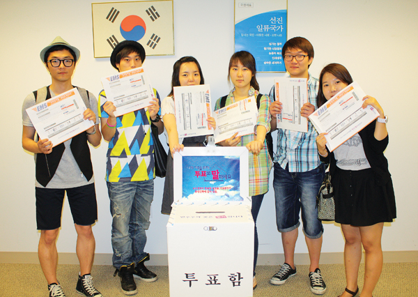 지난해 6월 재외국민 모의 선거에 참여한 한인 유학생들이 투표용지가 들어있는 봉투를 들어 보이고 있다.
