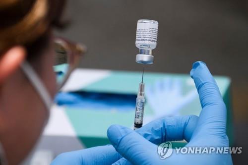 8월 미 캘리포니아 LA의 YMCA 이동식 코로나19 백신 클리닉에서 의료요원이 코로나19 백신 주사를 준비하고 있다.